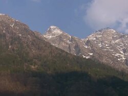 Low Angle pan-left - Snow dusts rocky peaks in the Italian Alps. / Italy Stock Footage