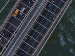 Aerial directly over Manhattan bridge following traffic Stock Footage