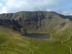 Aerial view Red Tarn lake at the foot of  Striding Edge of Helvellyn in the Lake District / Cumbria, England Stock Footage