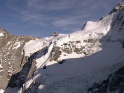 WS AERIAL View of Jungfraujoch north face with hangiong glacier,sphinx observatory at top of saddle / Jungfraujoch, Bern, Switzerland Stock Footage