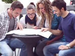 Group of friends consulting a map at bar Stock Footage
