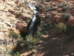 MS AERIAL View of Water fall around red rocks / Moab, Utah, United States Stock Footage