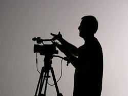 Videographer Cameraman Shooting and Directing; Silhouette Stock Footage
