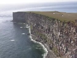 MS AERIAL View of Latrabjarg Lighthouse and peninsula / Iceland Stock Footage