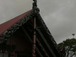 Pan down from traditional Maori roof to Maori Stock Footage