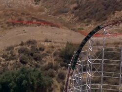 Aerial TS red roller coaster in Six Flags theme park / Valencia, California, United States. Stock Footage
