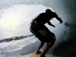 Breaking 20 foot wave crashes over surfer riding the barrel Stock Footage