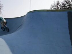 Teenage boy cycling on ramp at skateboard park Stock Footage