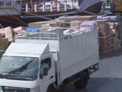 HA Truck is driving towards cargo area to drop off workers / Dubai, United Arab Emirates Stock Footage