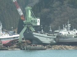 Damage in port area of Kesennuma City, Japan filmed on 1 April 2011, 3 weeks after a tsunami which was caused by magnitude 9 Tohoku earthquake off north east Japan / AUDIO Stock Footage
