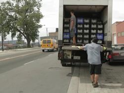 Men unload milk truk in south Chicago Stock Footage