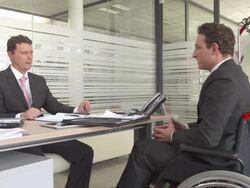 HD DOLLY: Handicapped Worker In Meeting Stock Footage