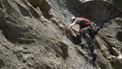 A young man rock climbing on a mountain. Stock Footage