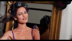 A woman takes a roller out of her hair Stock Footage