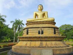 MS Shot of Golden seated Buddha statue at Viharamahadevi Park (Victoria Park) / Colombo, Western Province, Sri Lanka Stock Footage