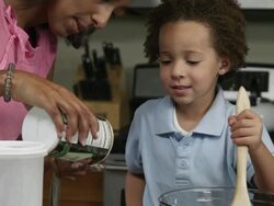 Slow motion pan of mother measuring salt. Stock Footage