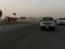MS TS Car travels down a road with two zig zag buildings under construction / Doha, Qatar Stock Footage
