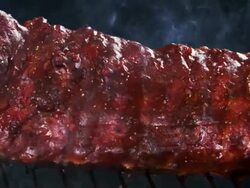 BBQ RIBS ON GRILL-SLOW MOTION Stock Footage
