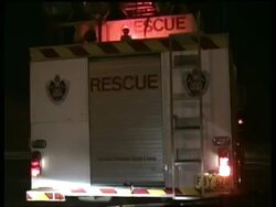 POV following fire rescue truck driving along street at night Stock Footage