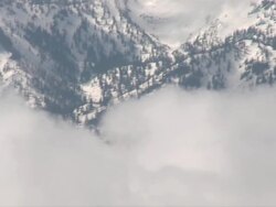 AERIAL WS POV View clouds and snow mountain / Montana, United States Stock Footage