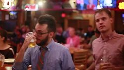 Viewers watching Hillary Clinton and Donald Trump debating on television laugh at Nick's English Hut in Bloomington, Indiana. Stock Footage