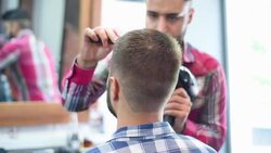 Hairdresser makes hairstyle with hairdryer bearded hipsters Stock Footage