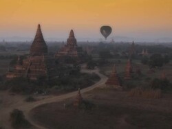 Aerial shot of temples and hot air balloons at sunrise in Myanmar Stock Footage