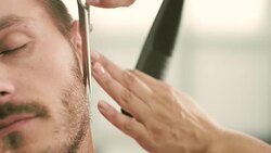 Barber cut a client's beard with clippers Stock Footage