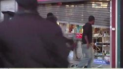 Rioters kicking in the windows of a shop News Clip