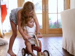 MS Shot of young girl helping her baby brother on his ride toy / Santa Fe, New Mexico, United States  Stock Footage