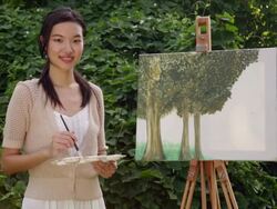 MS woman standing in front of a painting outdoors. Stock Footage
