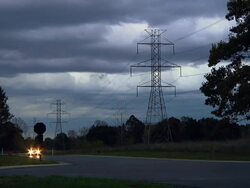 WS POV Electric car driving past high voltage power lines in countryside / Rochester, Michigan, United States Stock Footage