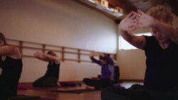 Group of women stretching in a yoga studio Stock Footage