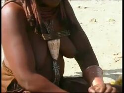 CU Tilt down, Himba tribeswoman grinding mixture for body paint, Namibia Stock Footage