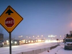 A stop sign and highway traffic behind Stock Footage