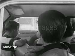 1961: THE SUBURBS: CAR POOLING: VS Mother in car w/ son, picking up other mothers & children, WS Station wagon driving away. IN CAR: Children looking at something, teenager in backseat moving to sit between twin boys, woman turning back to speak to b Instructional Video