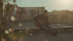 Hipster man playing acoustic guitar on the terrace Stock Footage