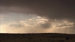 Storm clouds drift above the Kalahari Desert. Stock Footage