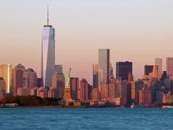T/L View of the Statue of Liberty and the One World Trade Center as seen from across the Hudson River at sunset  Stock Footage