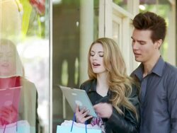 Man and woman window shopping with tablet Stock Footage
