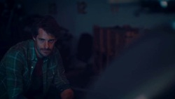 Man sitting in motorcycle workshop drinking coffe Stock Footage