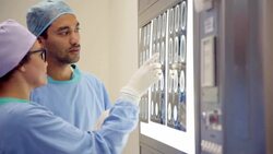 Surgeons discussing MRI scans Stock Footage