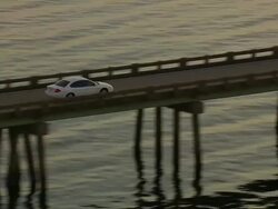 WS AERIAL TS View of Car on bridge with Sunset over Colington Island shore / North Carolina, United States Stock Footage