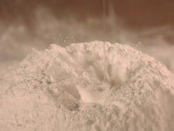 egg yoke falling into pile of flour in kitchen. Stock Footage