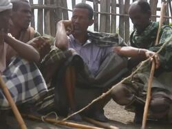 Ethiopian men gathered at camel market Stock Footage