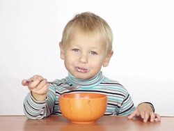 little boy eats with a fork Stock Footage