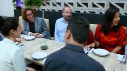MS PAN Multigenerational family sitting together at table in restaurant before dinner party Stock Footage