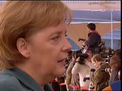 AP cover of heads of state arriving for summit, Merkel bite, pro Mugabe demo News Clip