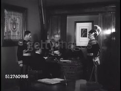 1940: VATICAN CITY: PONTIFICAL NOBEL GUARDS: Officers of Nobel Guard in full uniform in office around desk, talking together (no SOT), looking through booklet. Instructional Video