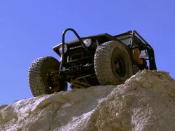 MS ZO Rock crawler rolling his jeep to top ledge of steep hill / Salton City, California, USA Stock Footage